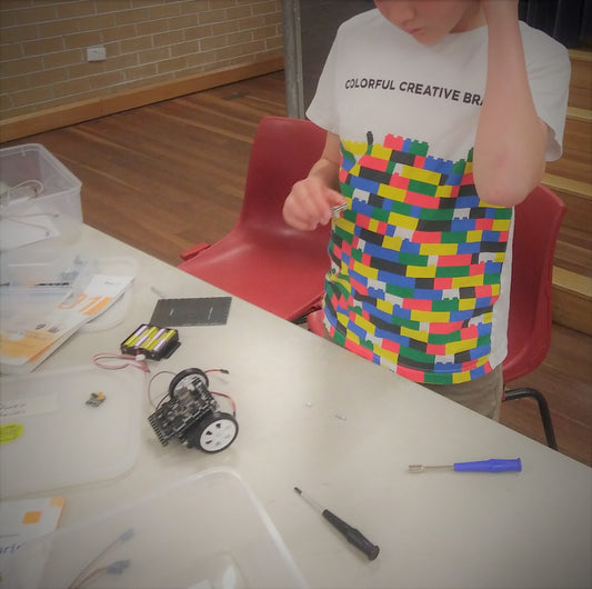 A boy is thinking how to build a robot