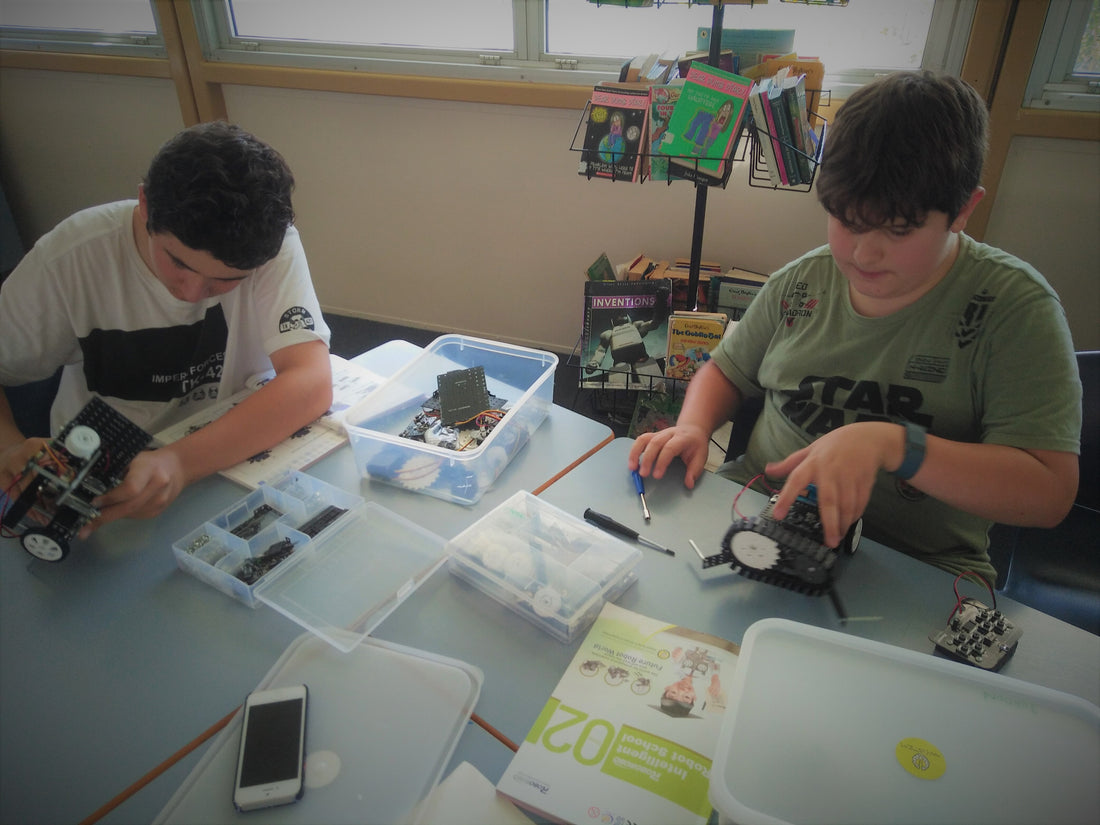 Build a robot and learn how to code it together with our cool students and team