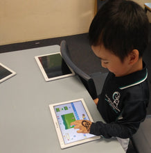 Load image into Gallery viewer, A child learns how to code in ScratchJr