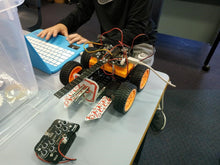 Load image into Gallery viewer, thinklum student finishes programming challenge for his robot