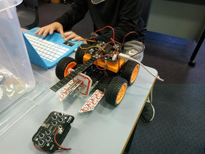 thinklum student finishes programming challenge for his robot